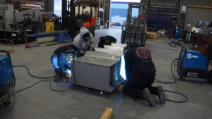 Skilled craftsmen welding custom fabrication project in Las Vegas shop.