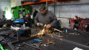 Custom fabrication shop in North Las Vegas, Nevada, with skilled craftsman using cutting tools on