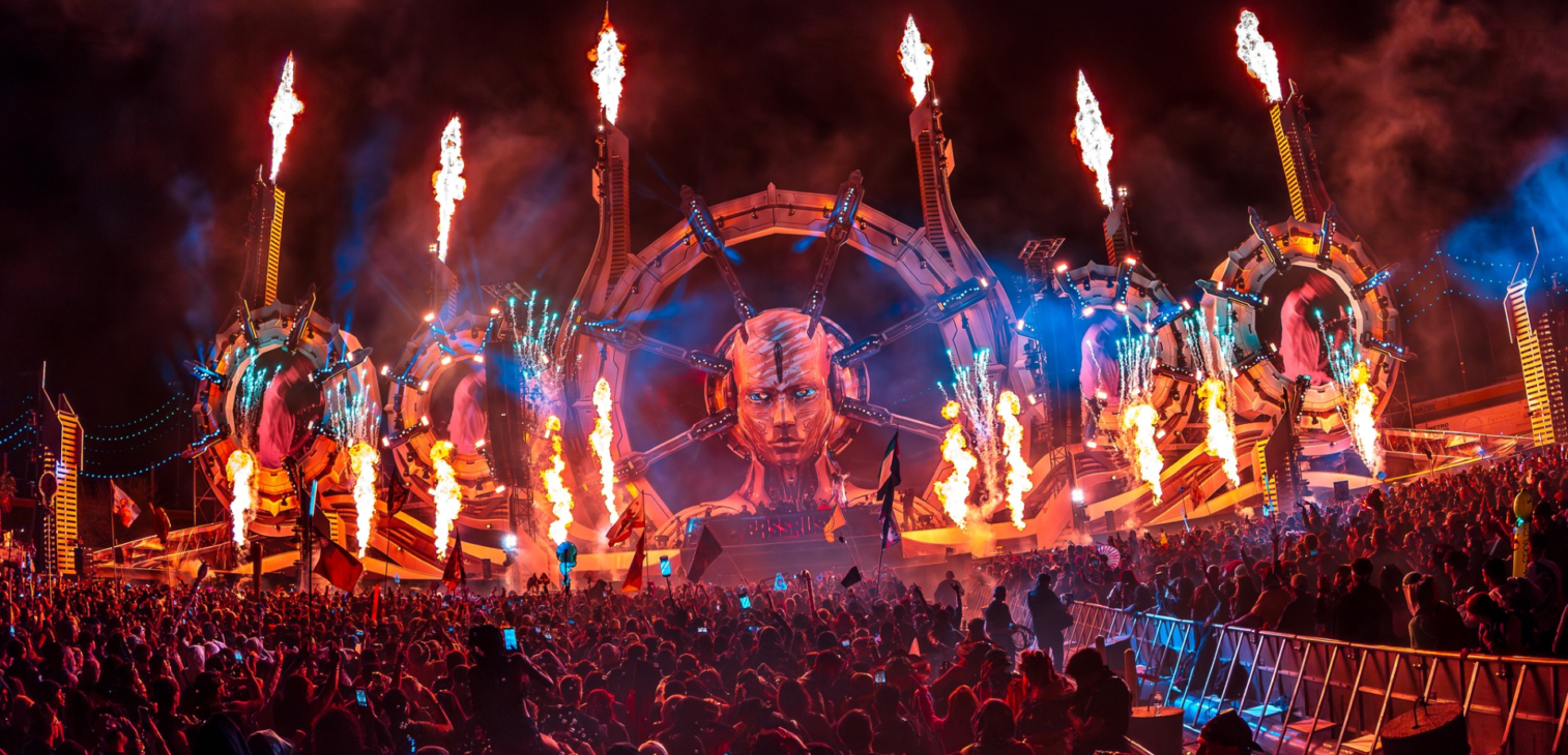 Large-scale stage fabrication for EDC festival featuring illuminated art and pyrotechnics.